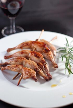 Honey glazed quail leg skewers